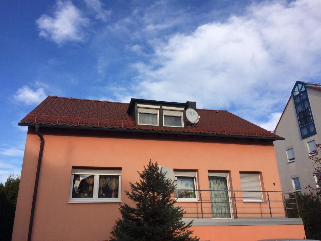 a house with a clock on the top of it at Ferienwohnung Nella in Amberg