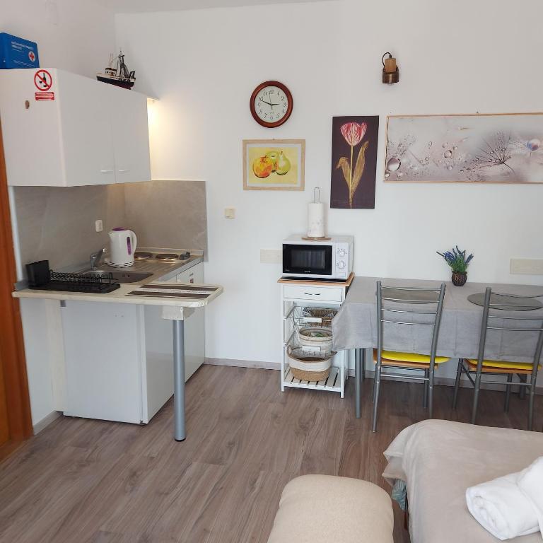a small kitchen with a table and a microwave at Jasmina in Senj