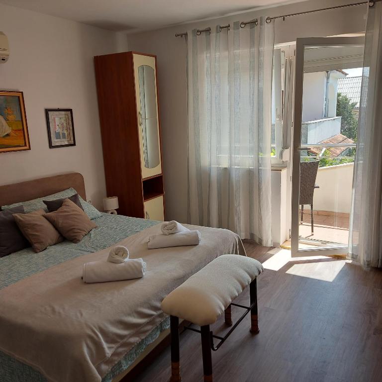 a bedroom with a bed with two towels on it at Jasmina in Senj