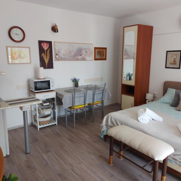a bedroom with a bed and a desk and a table at Jasmina in Senj