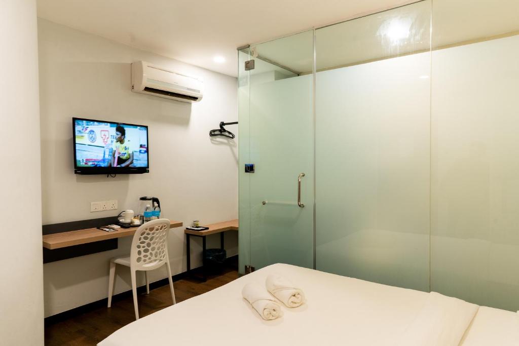 Postel nebo postele na pokoji v ubytování RM Hotel Muar