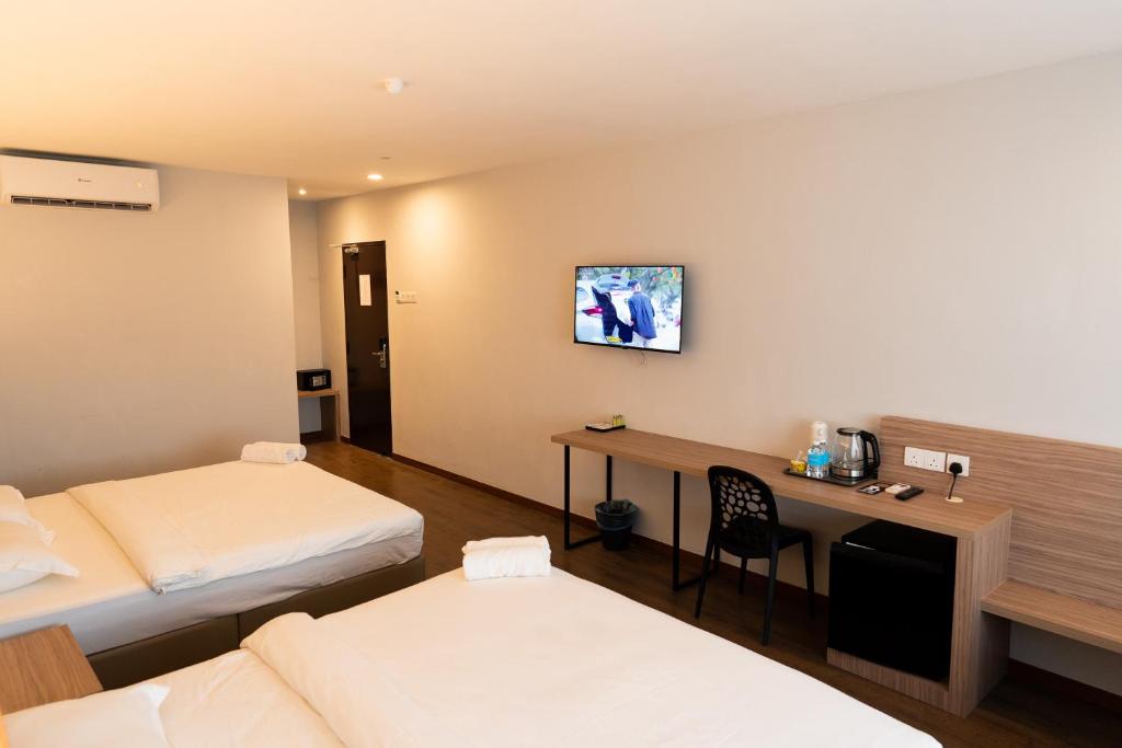 Postel nebo postele na pokoji v ubytování RM Hotel Muar