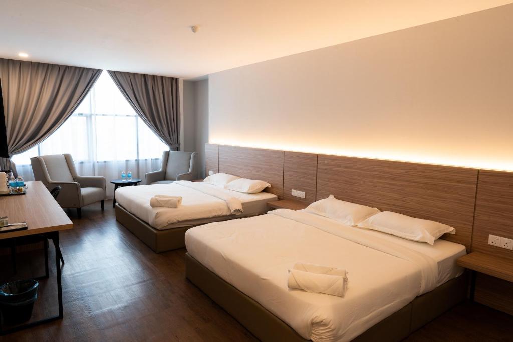 Postel nebo postele na pokoji v ubytování RM Hotel Muar