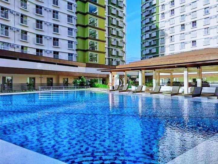 a large swimming pool in front of some buildings at Arthomes BB6 in Mandaue City