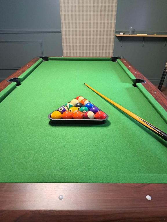 a pool table with a tray of balls on it at NAMASTE COTTAGE in Issigeac