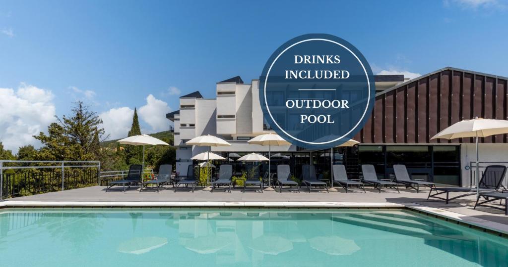 a pool with chairs and a sign in front of a hotel at Hotel Ad Turres in Crikvenica