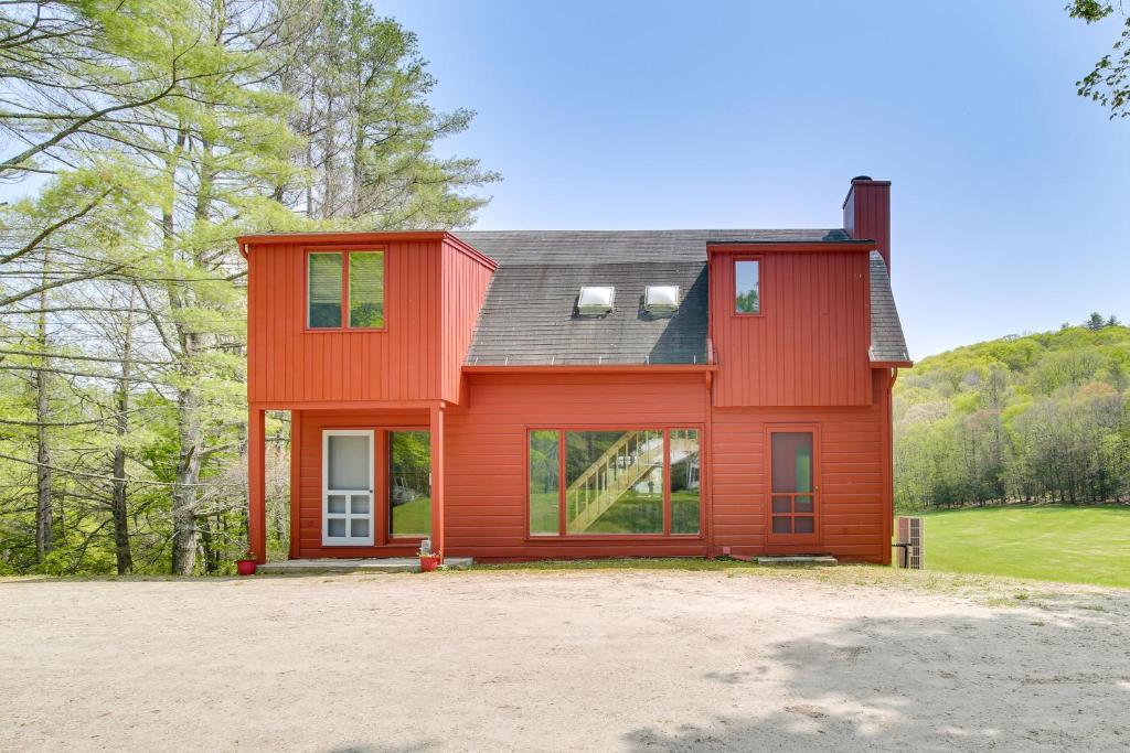 a red house with a black roof at Serene Salisbury Rental Home on 26 Acres with Deck! in Salisbury