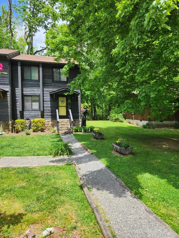 a house with a driveway leading to a yard at J.Creek Retreat, creekside townhouse +1 car garage in Maggie Valley