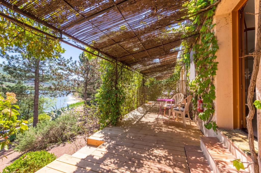 Le Mas de Riri في Celles: pergola with ivy on the side of a house