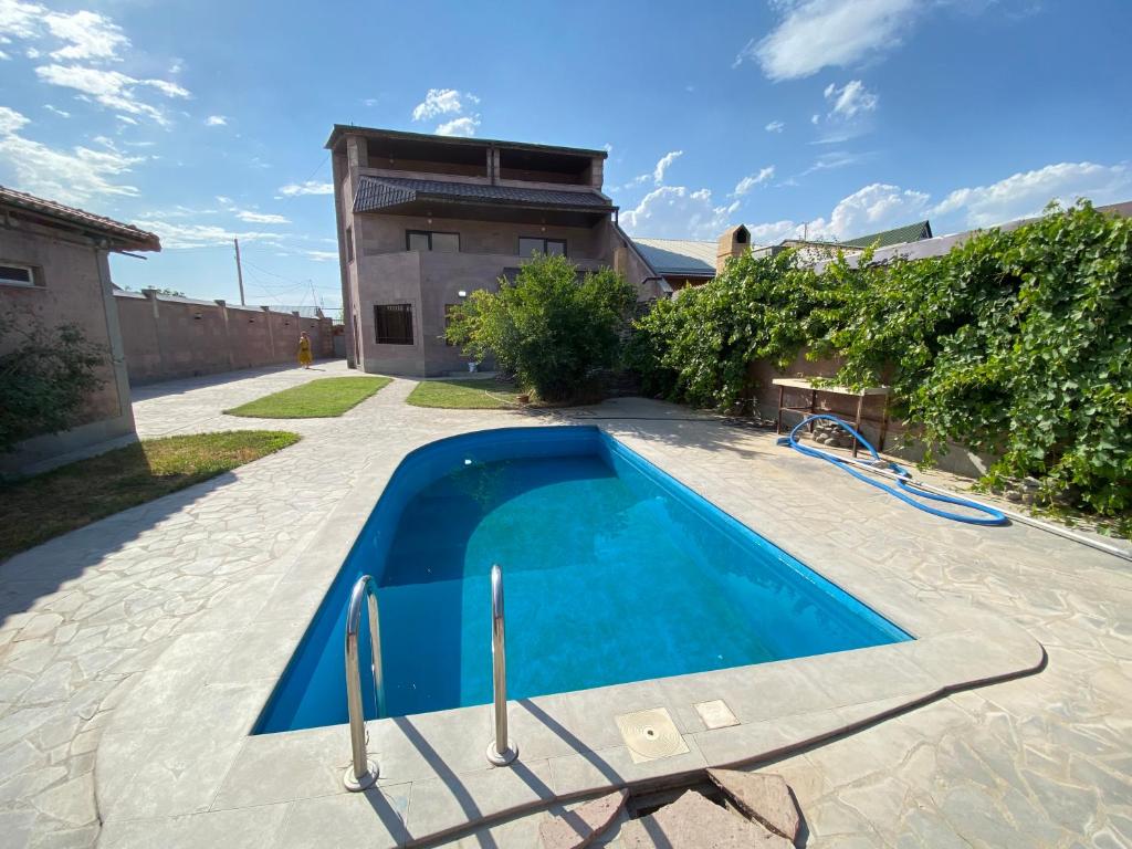 a swimming pool in front of a house at Luxury Villa with a Pool in Yerevan