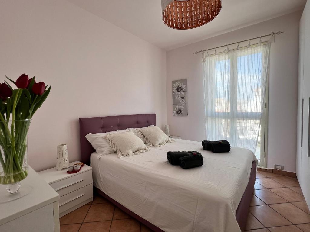 ein Schlafzimmer mit einem Bett mit zwei schwarzen Säcken darauf in der Unterkunft Apartment SunShine in Marzamemi