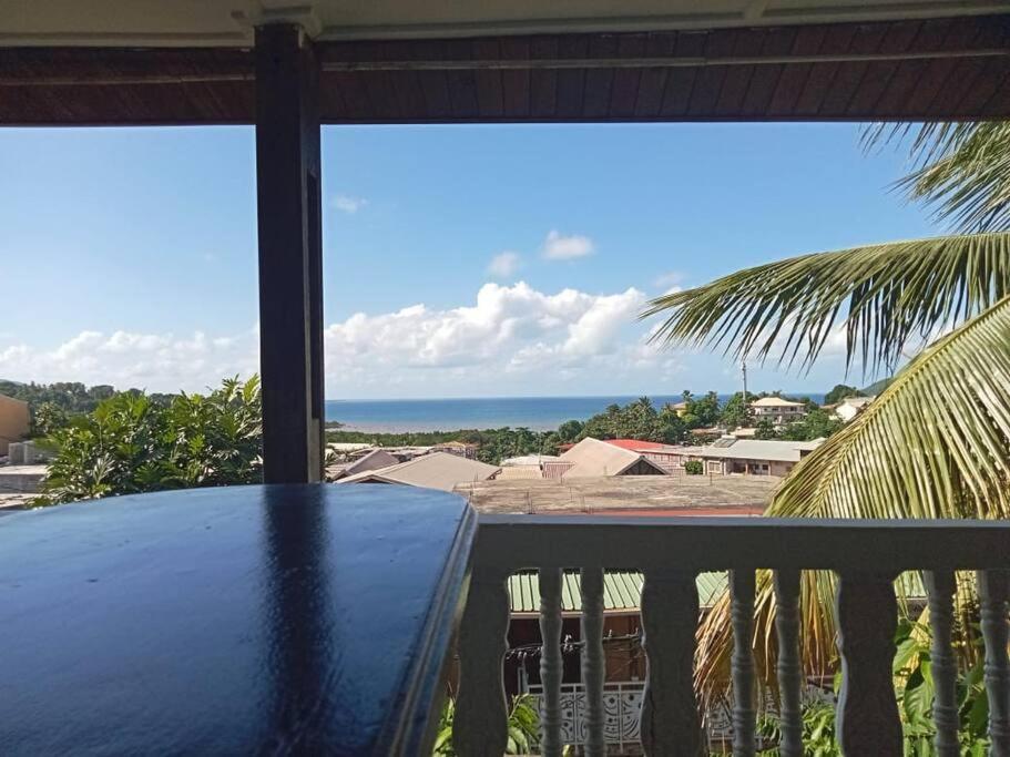 - une table sur un balcon avec vue sur l'océan dans l'établissement le moringa Appart vue mer 360 Mamoudzou hyper centre, à Mamoudzou