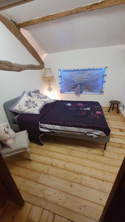 a bedroom with a bed and a window at Chateau Mano in Mairé-lʼEveseault