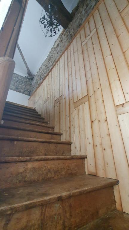 a set of wooden stairs in a building at Chateau Mano in Mairé-lʼEveseault