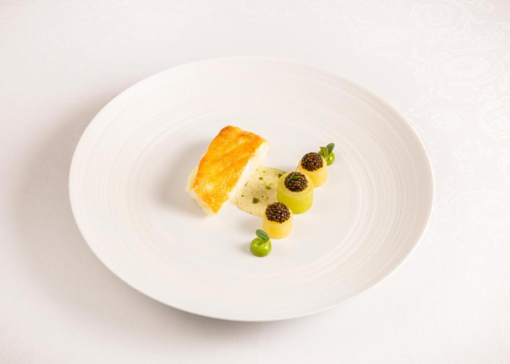 a white plate with some food on it at The Ritz London in London