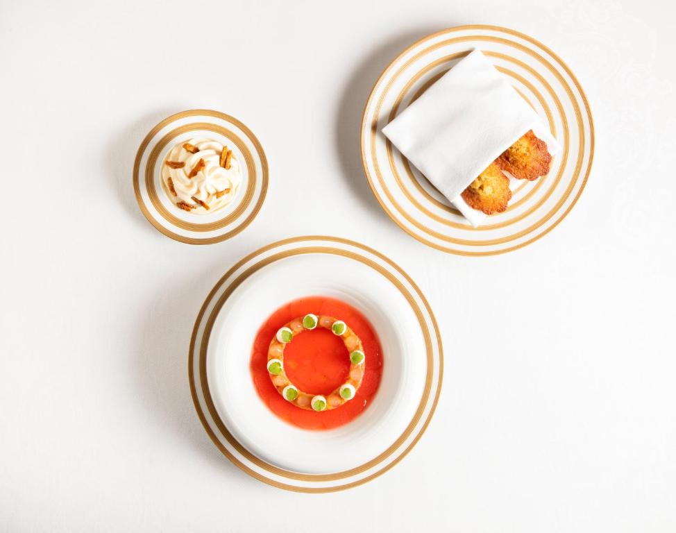 two plates with a doughnut on top of a table at The Ritz London in London