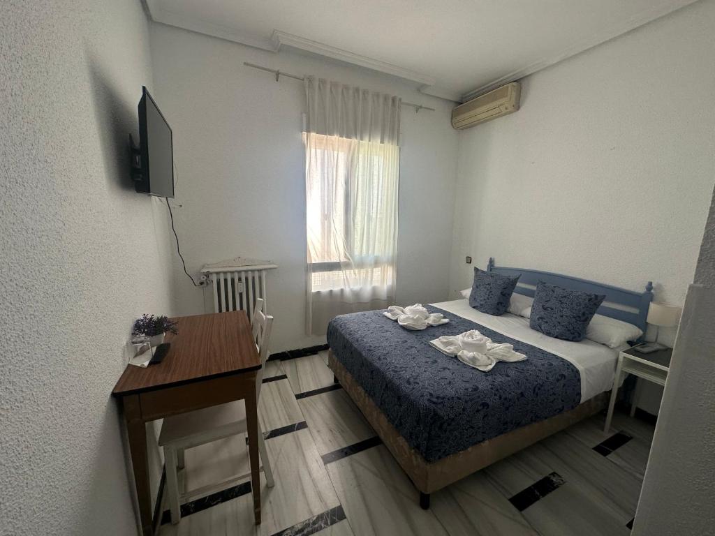 Postel nebo postele na pokoji v ubytování Hostal Arrate