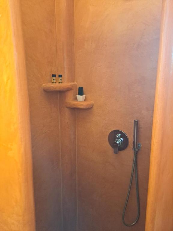 a bathroom with a shower with a sink and a toilet at Studios Irineos in Perissa