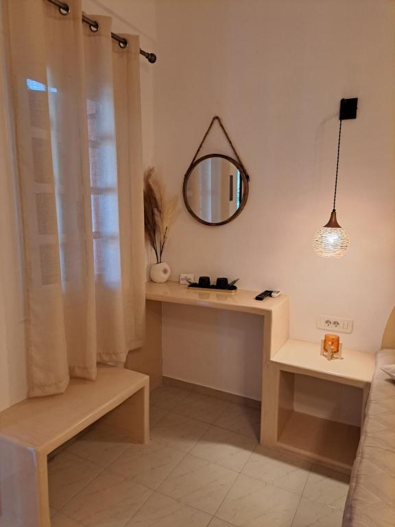 a room with a dressing table and a mirror at Studios Irineos in Perissa