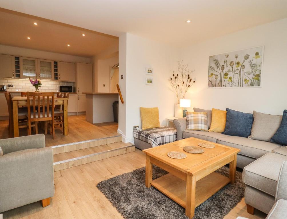 a living room with a couch and a table at Delabere Road in Bishops Cleeve