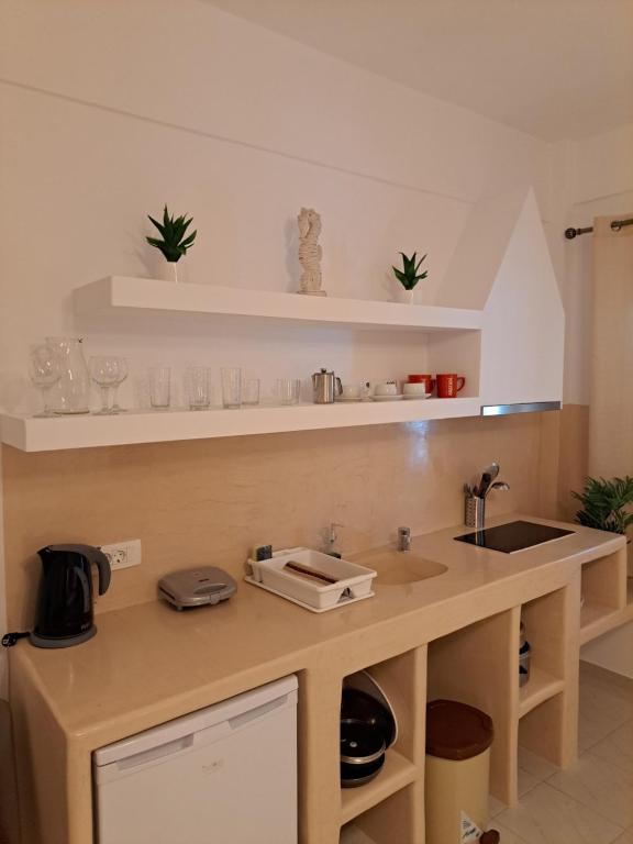 a kitchen with a sink and a counter top at Studios Irineos in Perissa