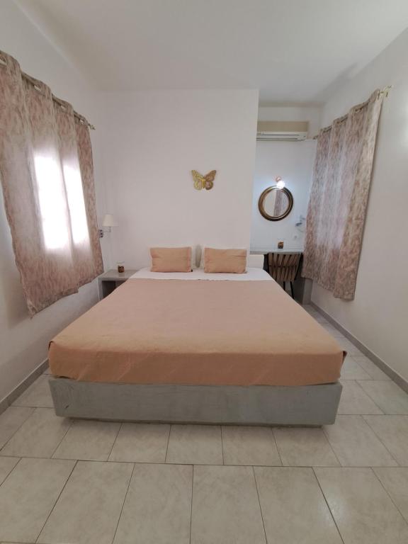a bedroom with a bed in a white room at Studios Irineos in Perissa