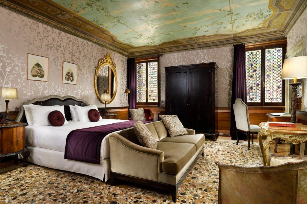a bedroom with a bed and a couch at Palazzo Venart Luxury Hotel in Venice