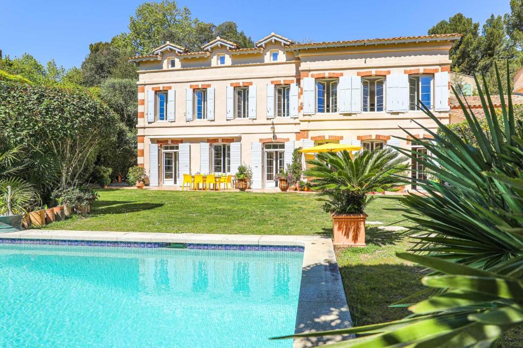 a large house with a swimming pool in front of it at Bastide les Oréades - Villa de luxe in Marseille