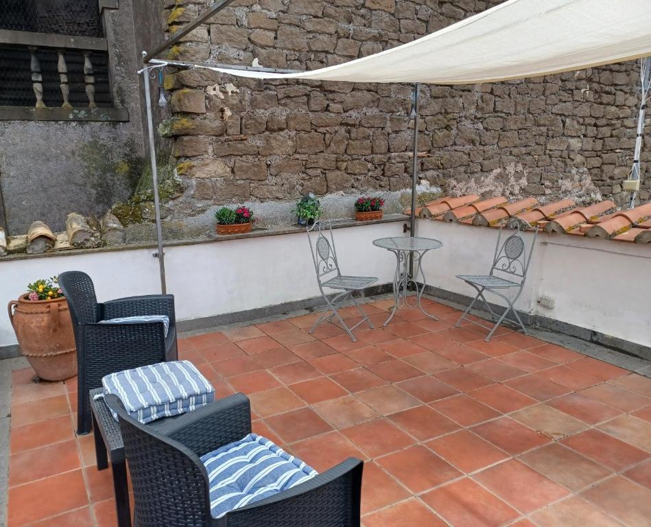 a patio with chairs and a table and a tent at CASA RE.ALE in Viterbo