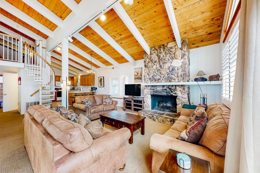 a large living room with couches and a fireplace at Saddle Road Sanctuary in South Lake Tahoe