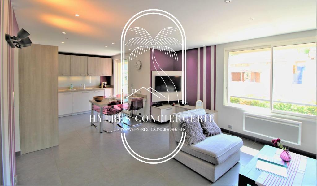 a living room with a white couch and a table at Appartement 3 étoiles coquet à 700m de la mer Les Bonnettes WiFi PK BY HC in Le Pradet