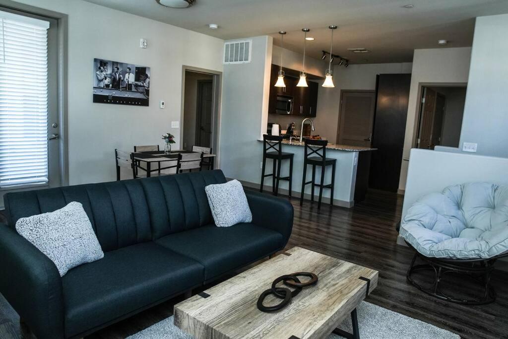a living room with a black couch and a table at Beautiful TownHome With Garage in Las Vegas in Las Vegas