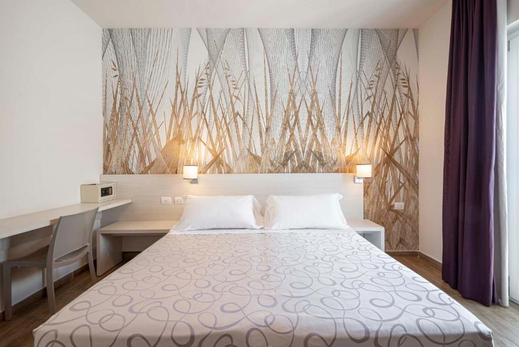 Postel nebo postele na pokoji v ubytování Hotel La Pineta