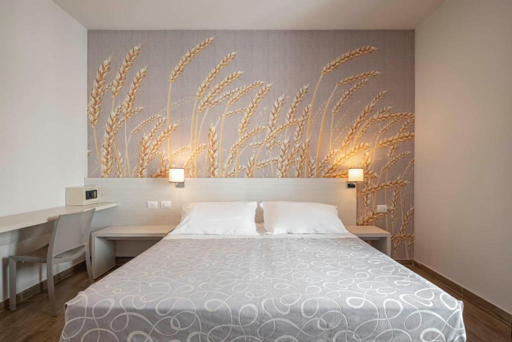 Postel nebo postele na pokoji v ubytování Hotel La Pineta
