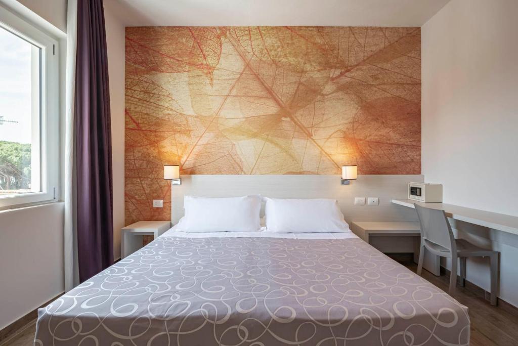 Postel nebo postele na pokoji v ubytování Hotel La Pineta