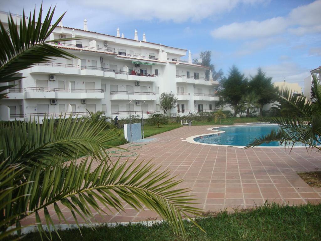 a large white building with a pool in front of it at Mantamar I in Manta Rota