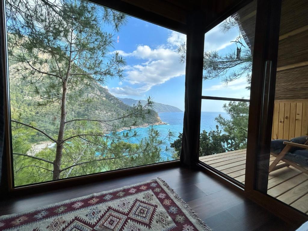 a room with a window looking out at the ocean at Kabak Ütopya Suites in Faralya