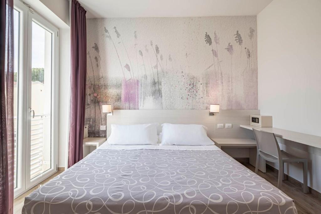 Postel nebo postele na pokoji v ubytování Hotel La Pineta