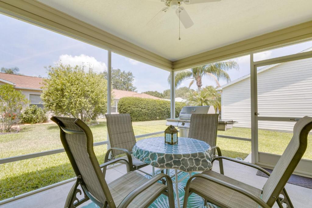 a screened porch with a table and chairs at Lanai and Golf Cart The Villages Vacation Rental! in The Villages