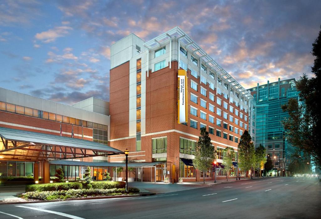 a large office building with a street in front of it at Georgia Tech Hotel and Conference Center in Atlanta