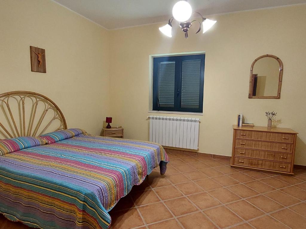 a bedroom with a bed and a dresser and a mirror at Tenuta Armida Relax & Pool in Liberi