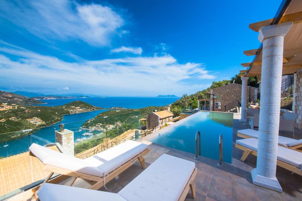 a villa with a swimming pool and a view of the ocean at Sivota Lefkas Luxury Villas in Sivota