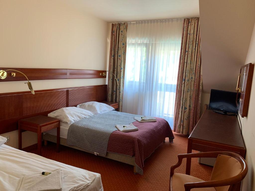Postel nebo postele na pokoji v ubytování OW LeśnyDwór