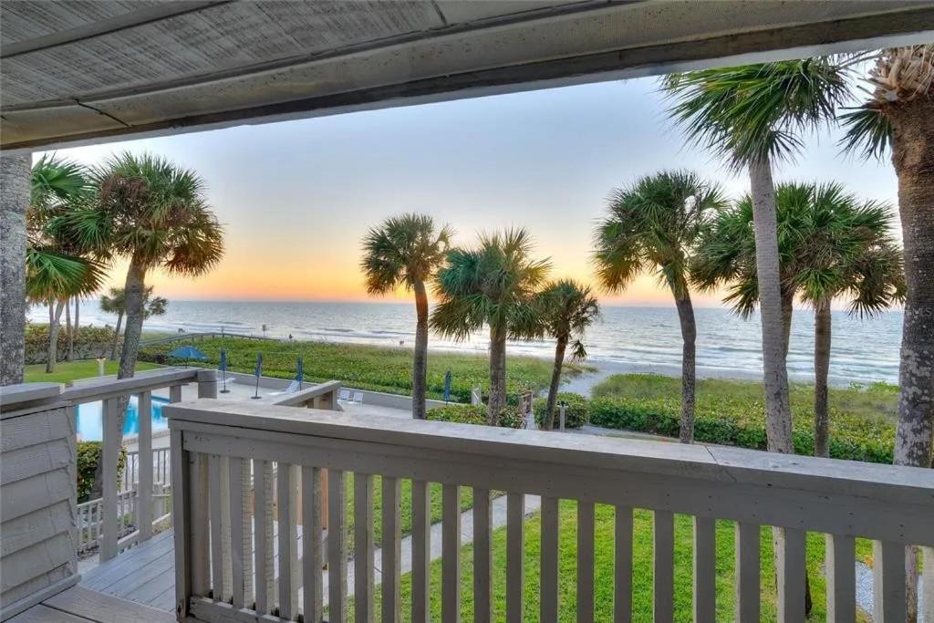 a balcony with palm trees and the ocean at Beachfront Aldea 14 in Clearwater Beach
