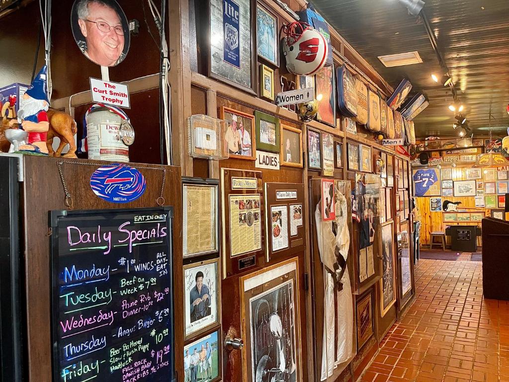 a room with a bunch of pictures on a wall at Buffalo Chip's Ranch House Motel in Bonita Springs