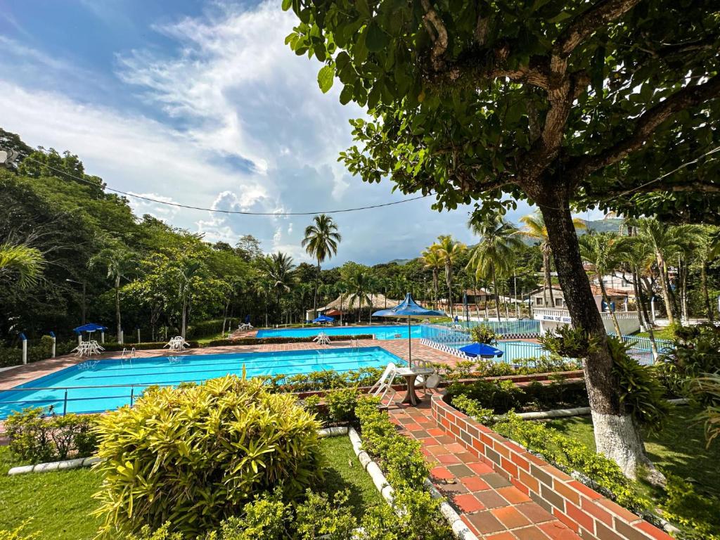 a large swimming pool with a resort at Cabaña Campestre in La Pintada