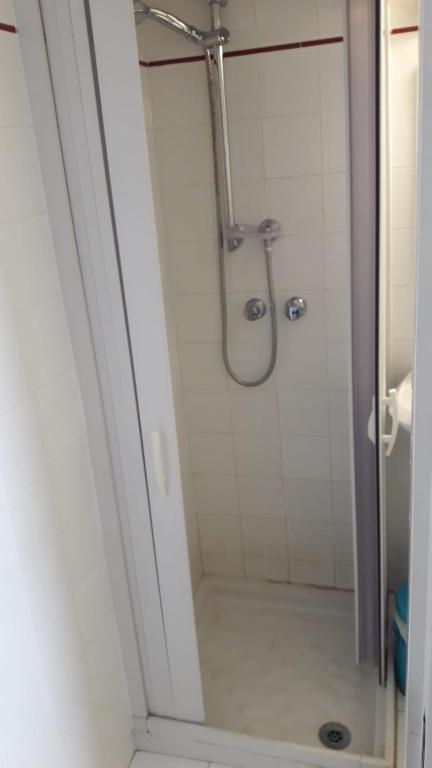 y baño con ducha y puerta de cristal. en Muri de mainè, en Ostuni