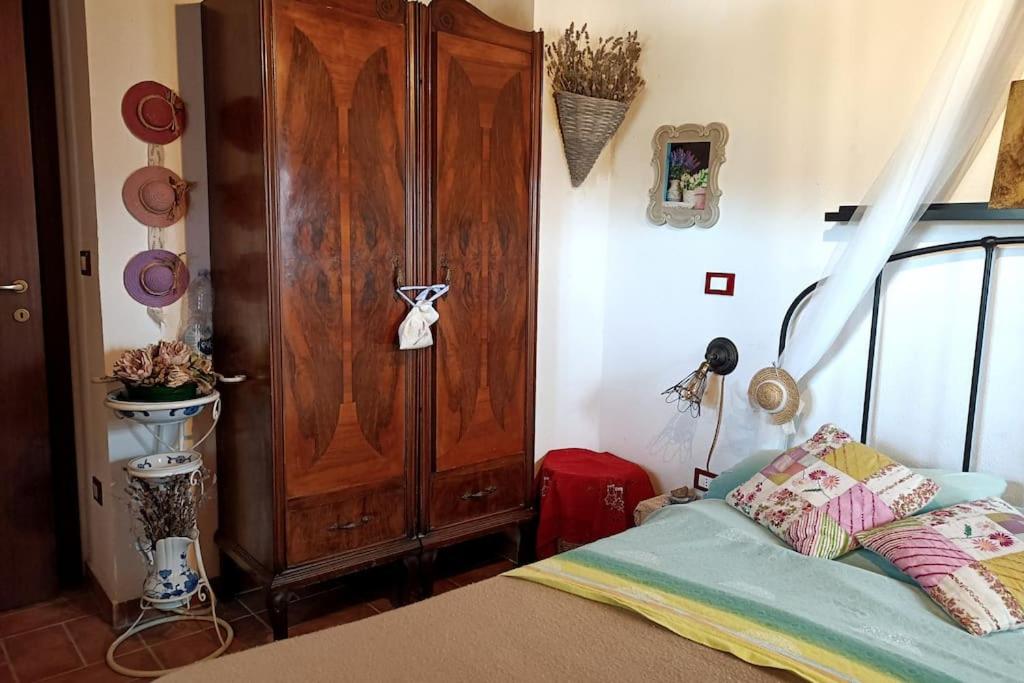 a bedroom with a bed and a wooden door at La casa della Rocca 