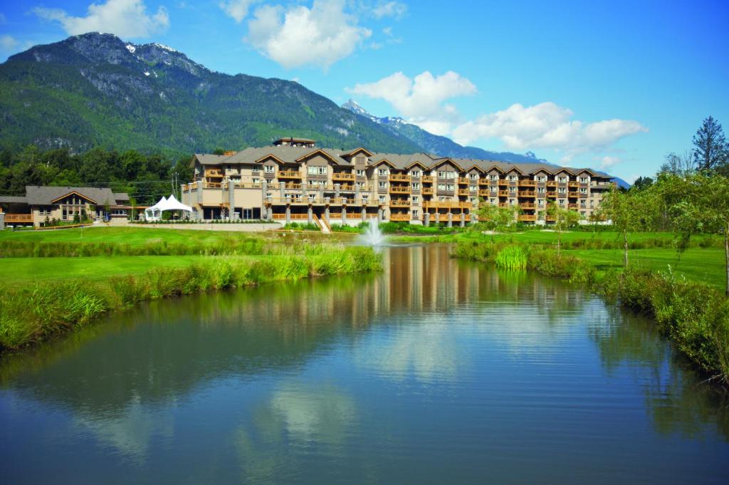 a hotel with a river in front of a resort at Executive Suites Hotel and Resort, Squamish in Squamish