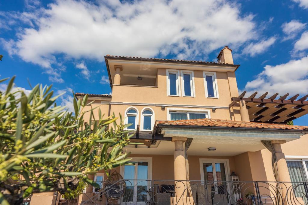 a yellow house with a roof at DOLLY LUX in Crikvenica